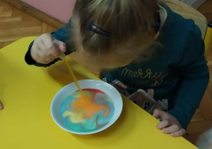 Dziewczynka maluje na mleku