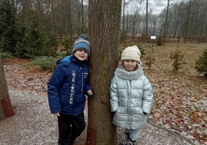 Dzieci stojące przy drzewie