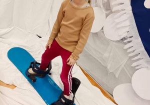 Dziewczynka na desce snowboardowej